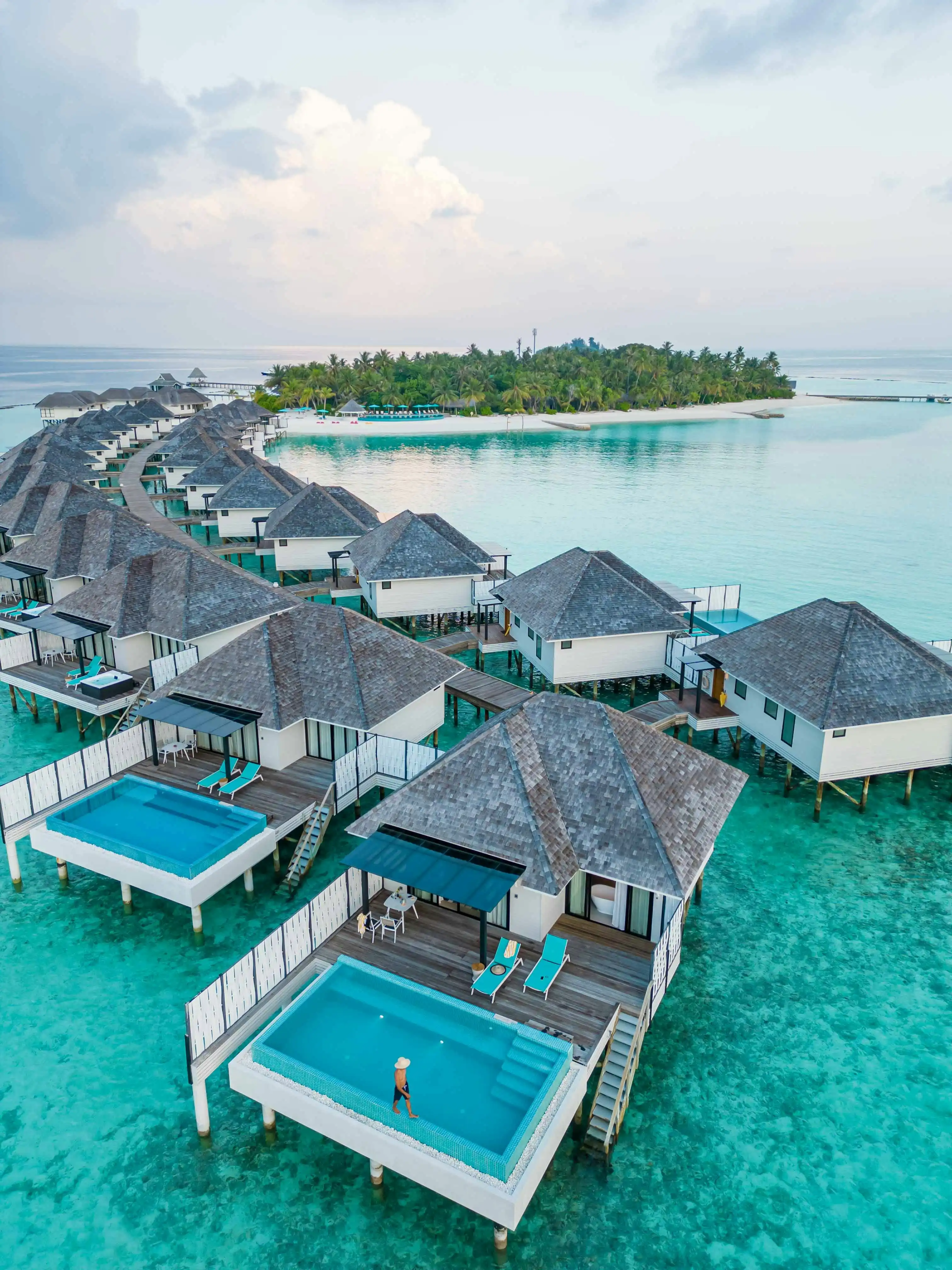 Water villas with private pools along a jetty in the Maldives