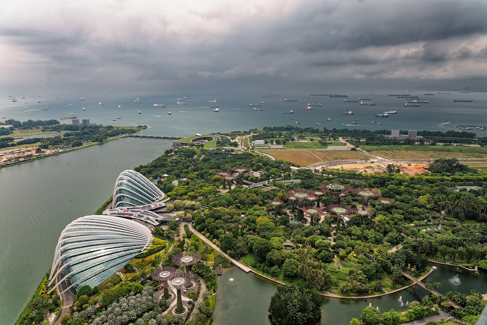 Gardens by the Bay from above: the two glass domes, the Supertree Grove and ships waiting in the strait