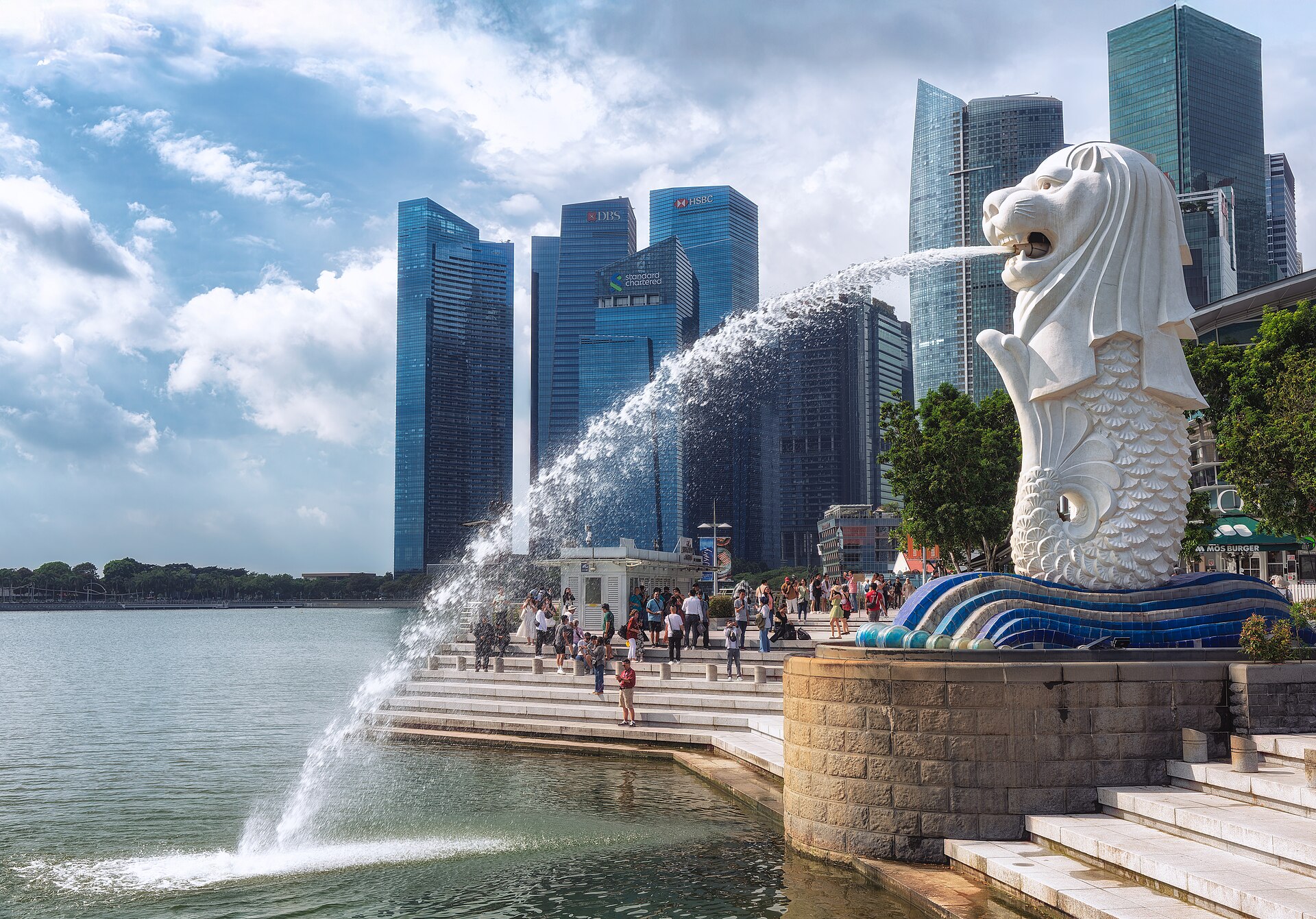 The Merlion spouting water into Marina Bay, with the towers of the business district behind